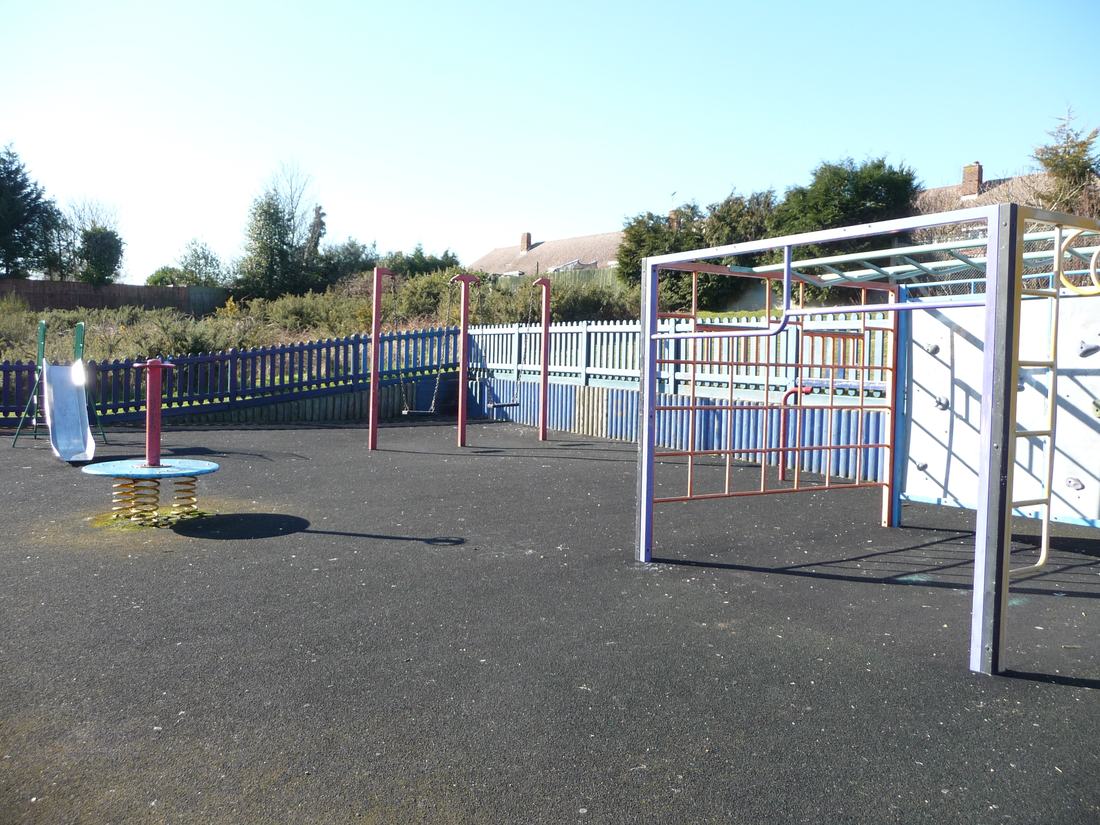 An empty playground with slides and swings