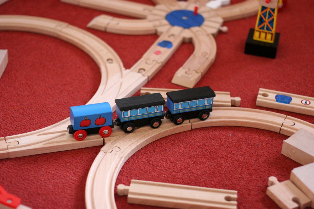 A wooden toy train on tracks